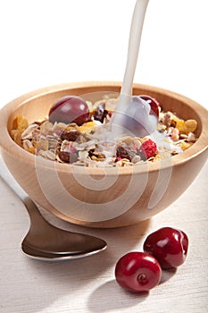 Milk pouring onto cereal with fresh isolated