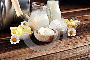 Milk products. tasty healthy dairy products on a table on. mozzarella in a bowl, cottage cheese bowl, butter swirls, glass bottle