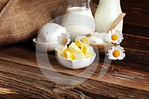 Milk products. tasty healthy dairy products on a table on. mozzarella in a bowl, cottage cheese bowl, butter swirls, glass bottle