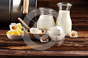 Milk products. tasty healthy dairy products on a table on. mozzarella in a bowl, cottage cheese bowl, butter swirls, glass bottle