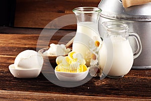 Milk products. tasty healthy dairy products on a table on. mozzarella in a bowl, cottage cheese bowl, butter swirls, glass bottle