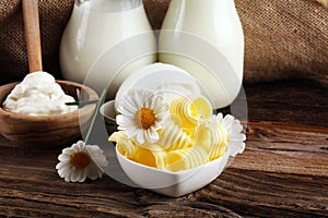 Milk products. tasty healthy dairy products on a table on. mozzarella in a bowl, cottage cheese bowl, butter swirls, glass bottle