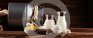 Milk products. tasty healthy dairy products on a table on. mozzarella in a bowl, cottage cheese bowl, butter swirls, glass bottle