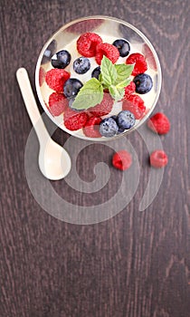 Milk pudding with berries in a glass