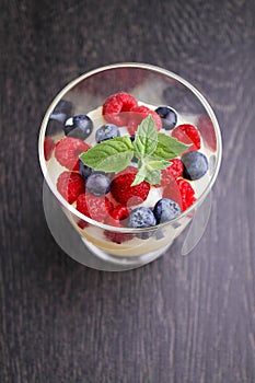 Milk pudding with berries in a glass