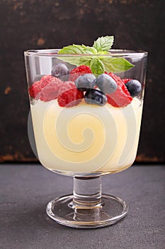 Milk pudding with berries in a glass