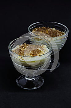 Milk pudding with vanilla ice-cream in glass dishes