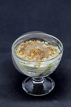 Milk pudding with vanilla ice-cream in glass dishes