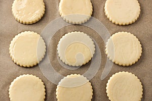 Milk shortbread before baking, greased with egg on parchment, top view. DIY, step by step, step 9