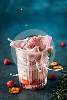 Milk smoothie strawberry, banana, raspberries in glass on dark blue background.