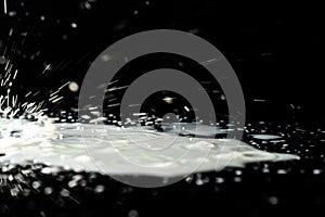 Milk spilled on black surface