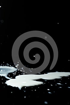 Milk spilled on black surface