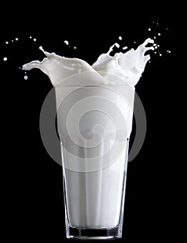 Milk splash on black background photo