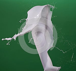 Milk splash in green matt background