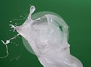 Milk splash in green matt background