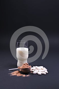 Milk and sports nutrition on a black background. Protein and food supplements.