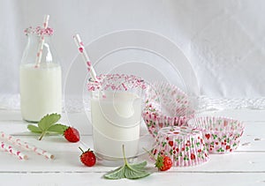 Milk with sugar sprinkles, strawberries and cupcake wrapper