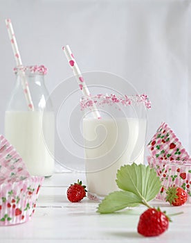 Milk with sugar sprinkles, strawberries and cupcake wrapper