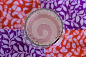 Milk Tea On Glass With Red Violet Pattern Background