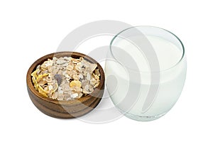 Milk in transparent glass and muesli multi fruit in wooden bowl isolated on white background