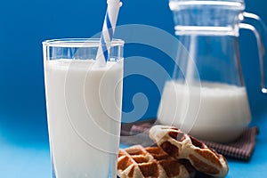 Milk with wafer on blue background