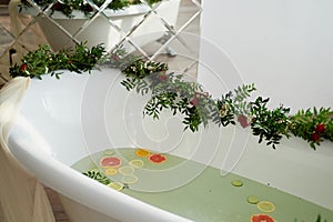 Milk water in the bath, which swim citrus: lime, lemon and grapefruit.Skin care and relaxation Bath filled with water