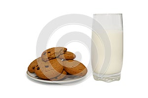Milk in a white glass and oatmeal cookies. Breakfast is dietary.