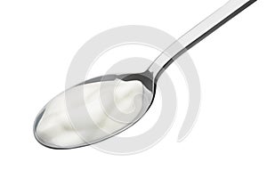 Milk yogurt in a spoon on a white