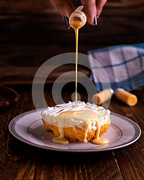Milkcake served in dish isolated on wooden table side view of arabic cafe food