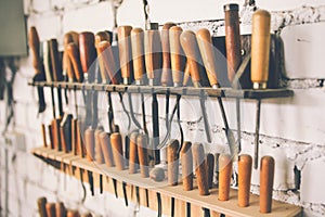 Milking tools for working with wood. Wood processing by hand. Carpentry tools on brick wall background