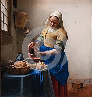 The milkmaid by Dutch golden age painter Johannes Vermeer photo