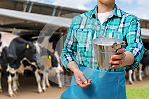 A milkmaid shows milk in a bucket