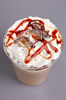 milkshake with caramel and chocolal on a gray background