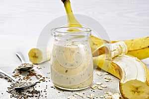 Milkshake with chia and banana in jar on table