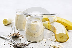 Milkshake with chia and banana in jars on table