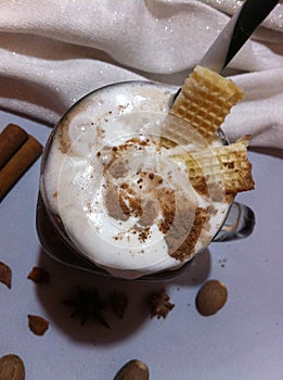 Milkshake with cream, spices, decorated with waffles and chocolate chips