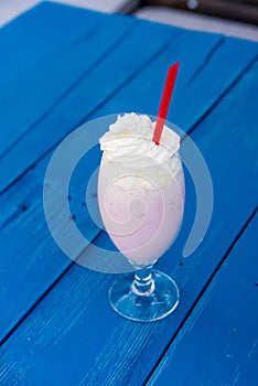 Milkshake with cream and straw in restaurant