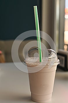 milkshake in a glass on the table in a cafe.