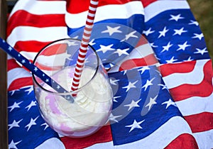 milkshake or smoothie with america flag patriotic symbols.picnic in nature on holiday.