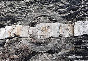 Milky Quartz Band in Dark Beach Rock in Maine