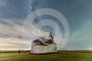 Milky Way and clouds with an abandoned church in North Dakota