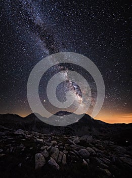 Milky Way galaxy and mountain peaks.