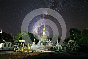 Milky way on night sky at white pagoda