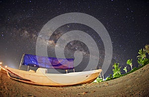 Milky way over fisherman boat at Mabul Island. Visible noise due