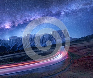 Milky Way over mountain road at night in summer