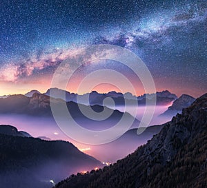Milky Way over mountains in fog at night in summer. Landscape