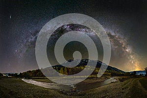 Milky way over the Piatra Craiului mountains and river from Romania