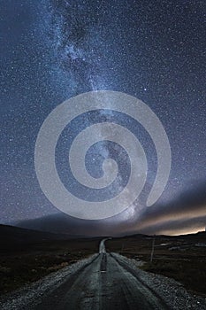 Milky Way over the road in Stugudalen near Sylan mountains, Norway. Autumnal night sky