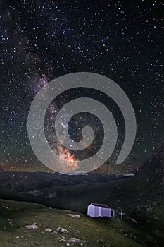 Milky Way over the Swiss alps with the chapel Mary to the Snow