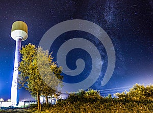 The Milky Way Over A Water Tower With Stars